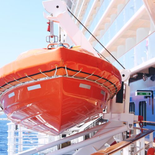 bright orange life boats on cruise ship